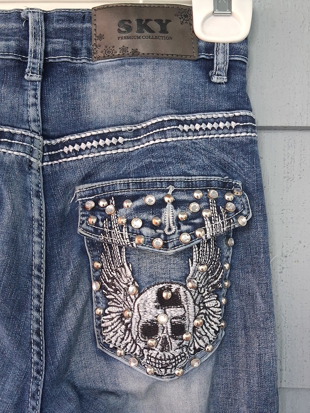 Sky Denim Jeans with Studded Winged Skull Pocket